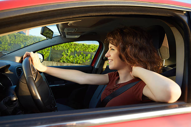 istock young woman driving a new car 613303424