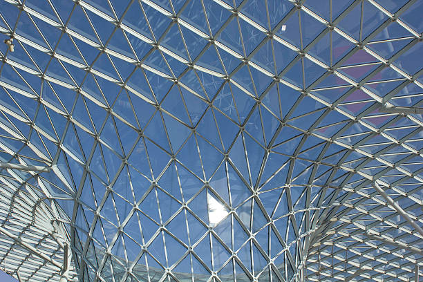 Architectural close up of the glass roofing of Milano Fiera Milan, Italy - April 15, 2015: Architectural close up of the glass roofing of Milano Fiera, lookin up with nobody (area before the entrance of the fair, public space) fiera stock pictures, royalty-free photos & images