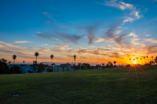 Ventura Cemetery Park under sun rays peeking over ocean horizon.