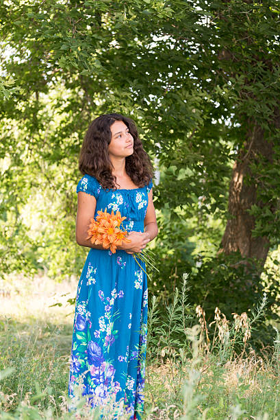 Girl with  bouquet of lilies in the park stock photo