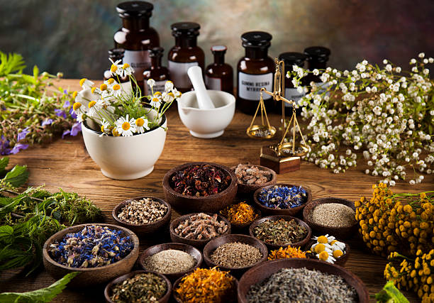 istock Natural medicine, herbs, mortar on wooden table background 613306858