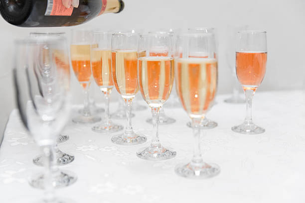 istock waiter pours champagne into glasses 613307126