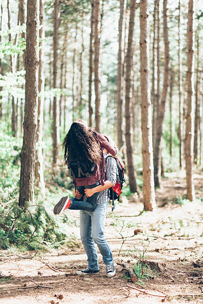 istock Young couple having fun in the forest 613307478