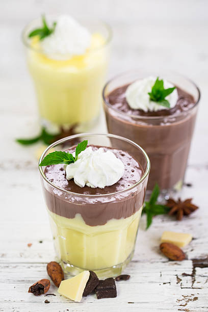 istock Chocolate and vanilla pudding with whipped cream 613310998