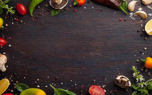 istock Various vegetables and herbs on dark wood table 613311754