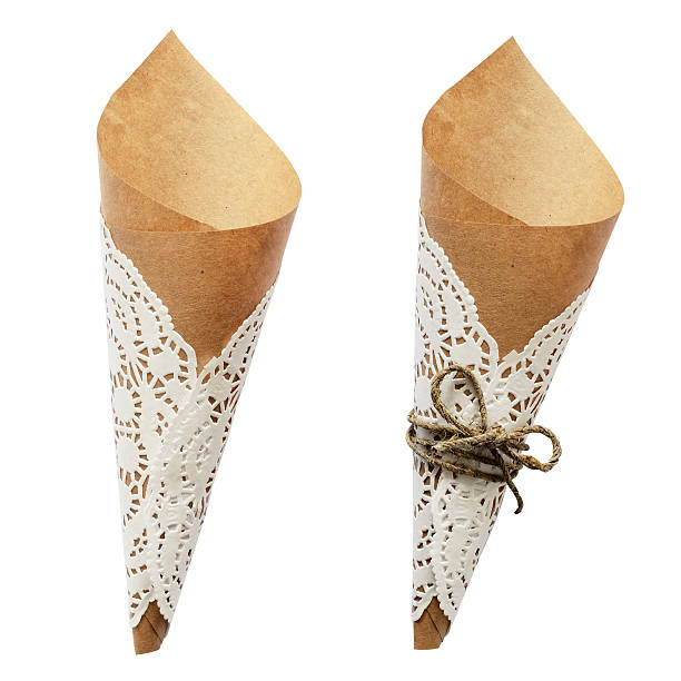 istock Empty craft paper cornets with tied rope bow and doily 613312542