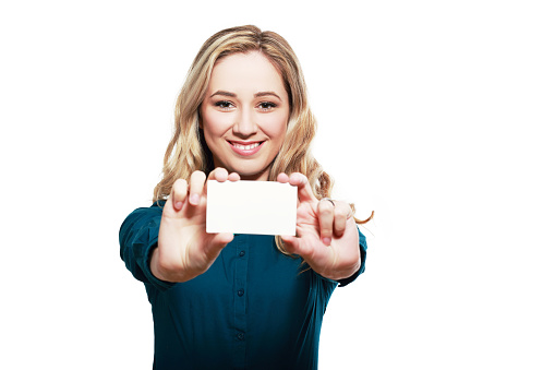 Smiling business woman hold white credit card. Isolated portrait.