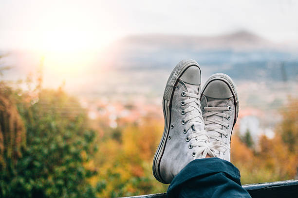 istock Young man relax on bed and enjoying mountain view. 613313908
