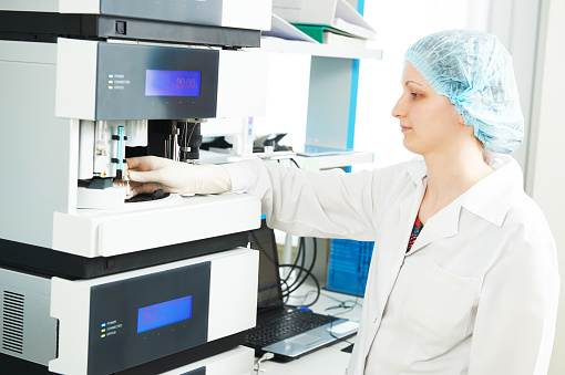Pharmaceutical scientific researcher analyzing liquid chromatography data at pharmacy industry manufacture factory laboratory