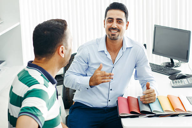 istock Two bussinesman discussing project design in office 613317946