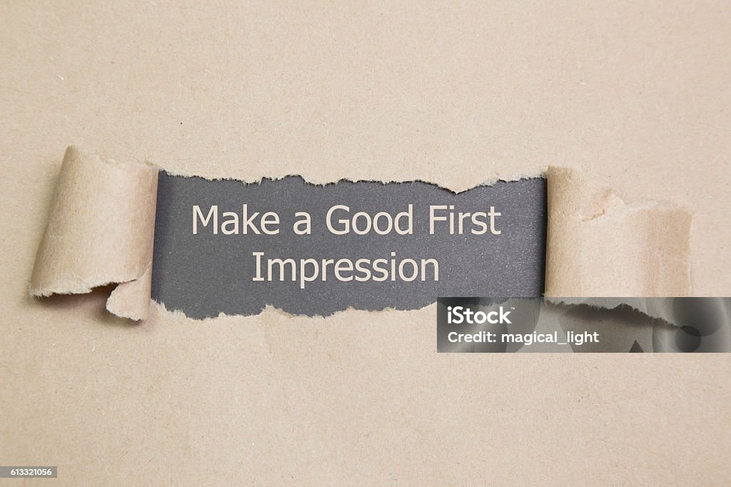 Make a Good First Impression Make a Good First Impression message written under torn paper. Beginnings Stock Photo