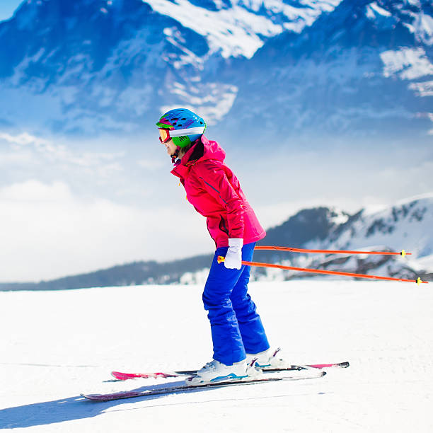 istock Young active woman skiing in mountains on  sunny winter day 613321118