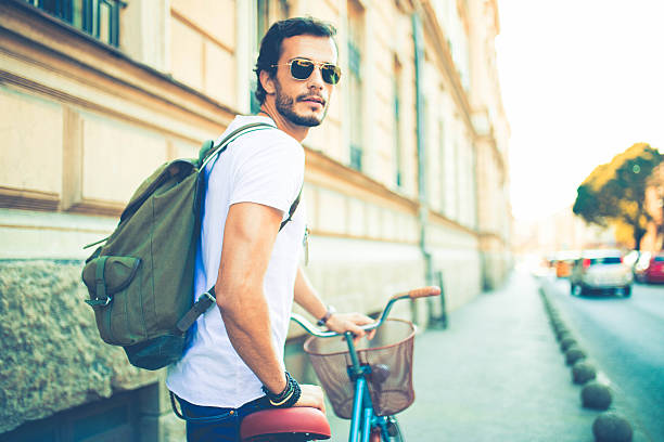 istock Hipster exploring the city by bike 613324520
