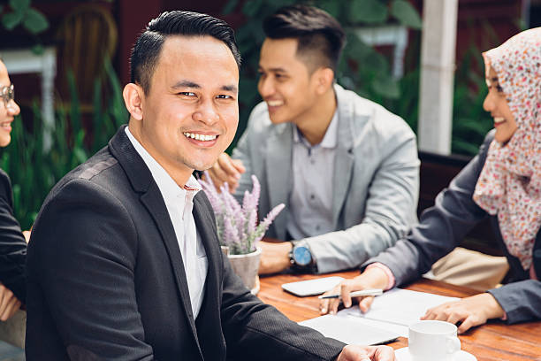 istock handsome businessman smiling at the camera 613326246