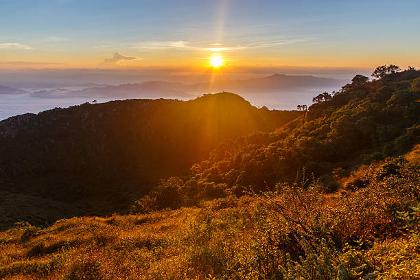 istock Layer of mountains and mist at sunrise time 613328028