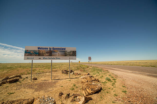 "Welcome to Queensland" Queensland, Australia - May 12, 2016: "Welcome to Queensland" sign standing beside the highway in the outback. queensland stock pictures, royalty-free photos & images