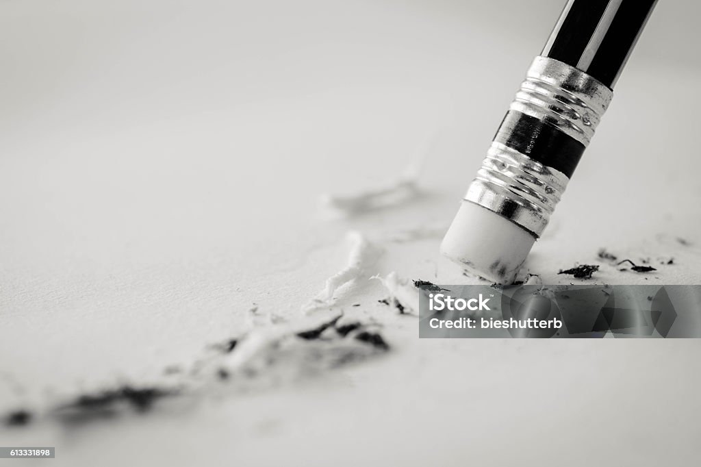 pencil eraser. pencil eraser removing a written pencil eraser. pencil eraser removing a written mistake on a piece of paper, mistake concept, black and white business tone. Eraser Stock Photo