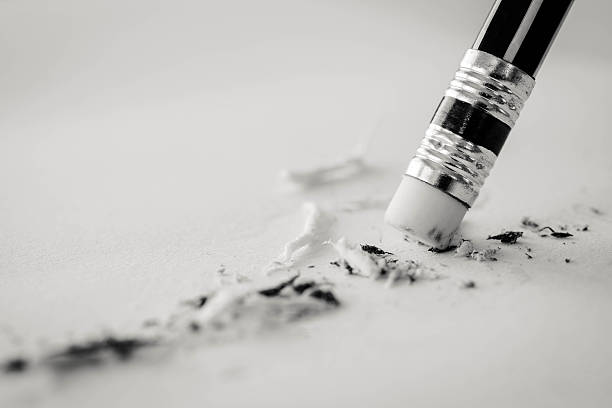 pencil eraser. pencil eraser removing a written pencil eraser. pencil eraser removing a written mistake on a piece of paper, mistake concept, black and white business tone. eraser photos stock pictures, royalty-free photos & images