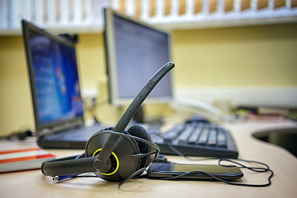 istock headset keyboard notebook laptop in office on table desk 613332438