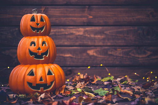 Fall celebrations. Halloween Jack O Lanterns with leaves