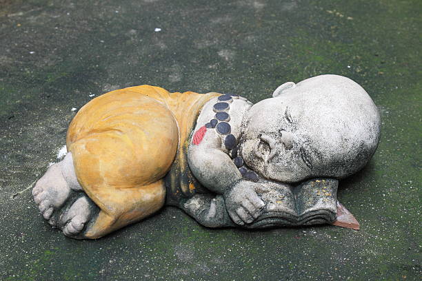 istock Earthenware Buddhist Novice with beads necklace is sleeping. 613334072