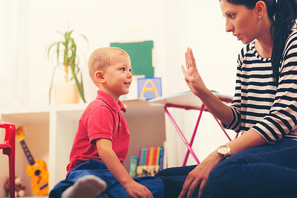 istock Child boy and mother playing with educational toy 613334124