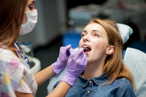 Dentista curando a un paciente infantil en el consultorio dental photo