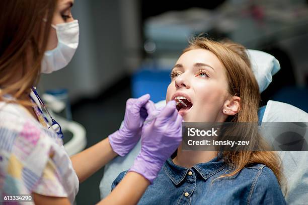 Dentist Curing A Child Patient In The Dental Office Stock Photo - Download Image Now