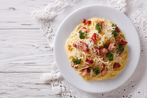 Italian food: pasta carbonara on the table. horizontal view from above