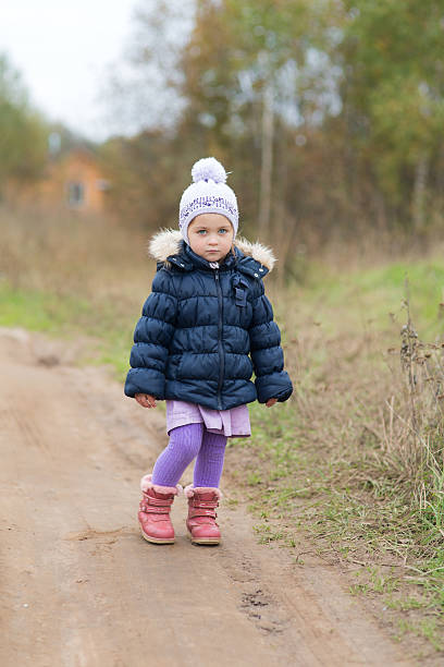 istock little girl on a dirt road 613334820