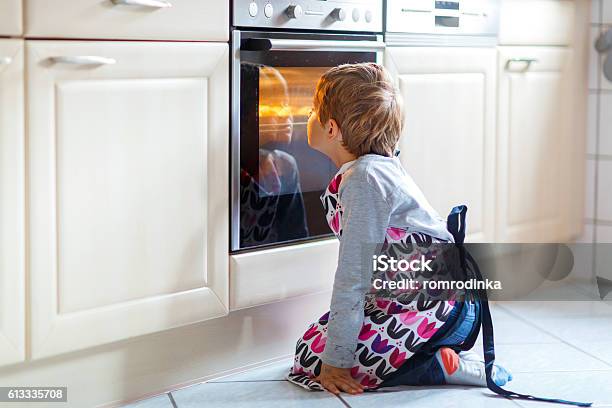 Funny Blond Kid Boy Baking Muffins Indoors Stock Photo - Download Image Now - Child, Baking, Cookie