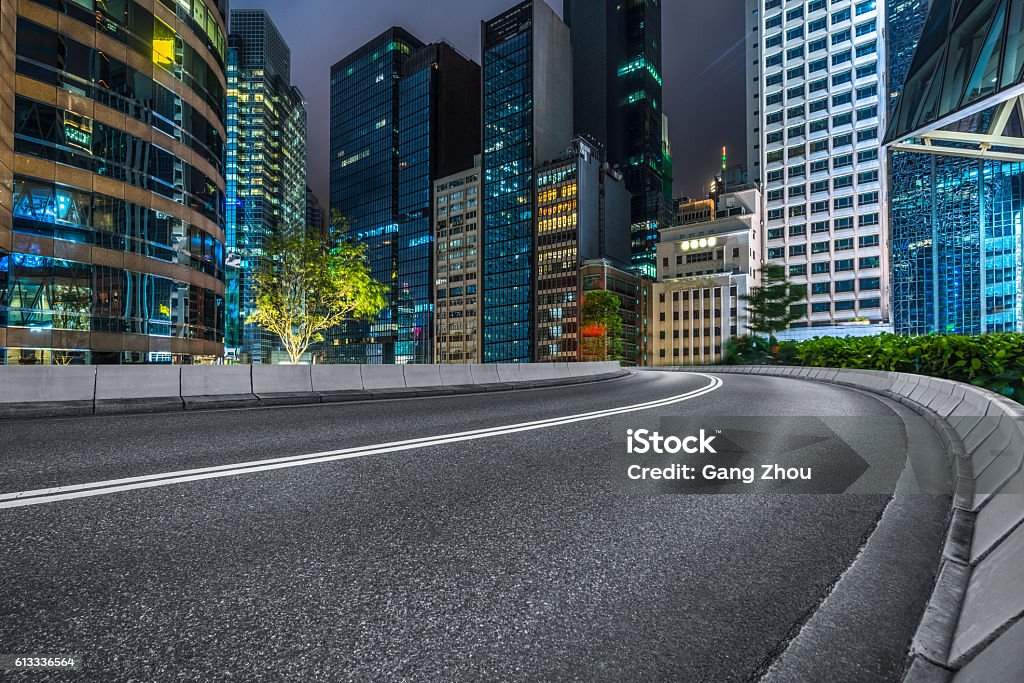 Professional use auto advertising backplate clean road with modern  illuminated buildings background,Hong Kong,china,asia. Architecture Stock Photo