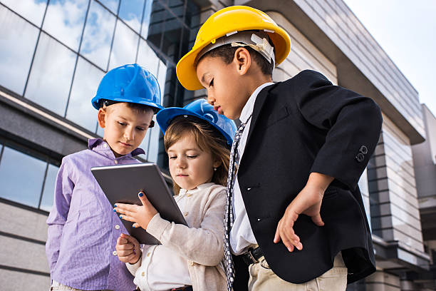 istock Team of small architects working on digital tablet outdoors. 613336584