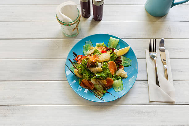 istock Healthy restaurant food, salmon and cod fish salad closeup 613336718