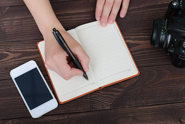 istock Top view of a hands with pen and notepad 613337380