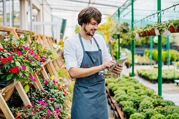 istock Gardener with digital tablet in a greenhouse 613337628