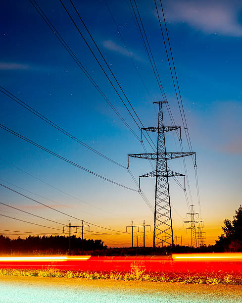 istock Silhouettes high voltage electric pylon in sunset background 613338612