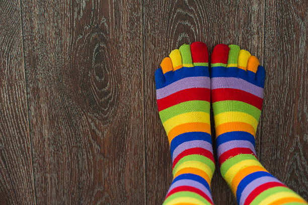 istock Close-up photo woman's feet in multi color socks 613340320