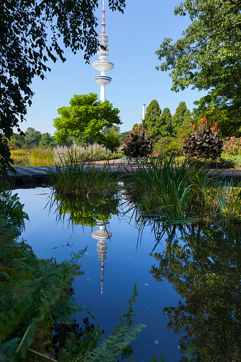 Heinrich-Hertz Communications tower reflecting in a pond in Planten un Blomen, Hamburg, Germany