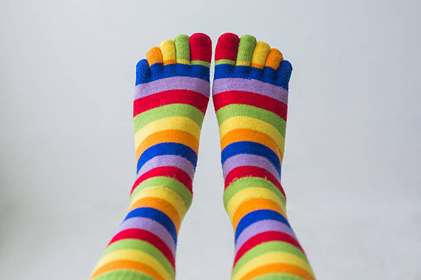 istock Close-up photo woman's feet in multi color socks 613340556