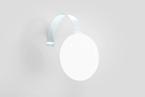 Blank white wobbler hanging on wall mockup, clipping path Blank white wobbler hanging on wall mockup, clipping path, 3d rendering. Space round paper mock up on plastic transparent strip. Clear price sticker circle shape. Pricing tag label template isolated. print ad mockup stock pictures, royalty-free photos & images