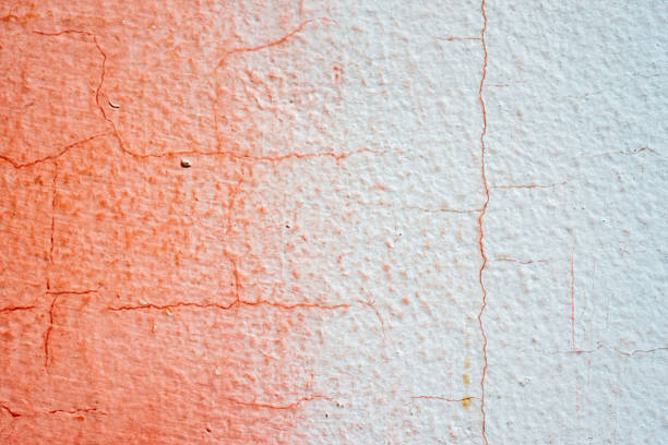 istock cracked painted red and white concrete wall 613341596
