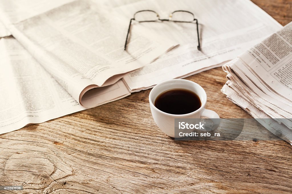 Newspaper with coffee on table Newspaper Stock Photo