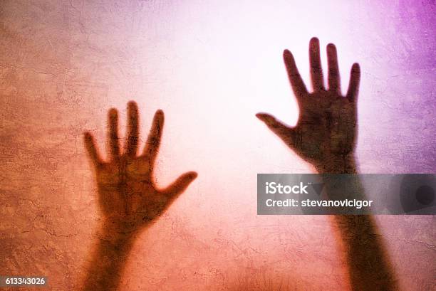 Captured Person Back Lit Silhouette Of Hands Behind Matte Glass Stock Photo - Download Image Now