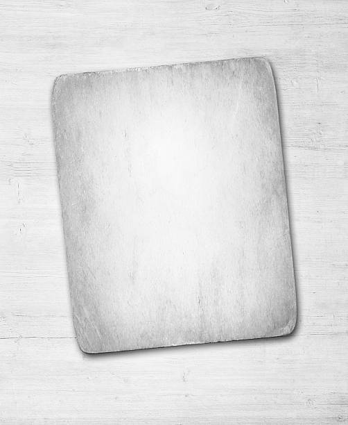 istock Old dirty paper with shadow on white wooden wall or 613343398