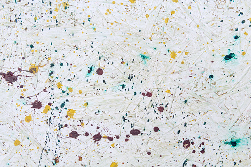 Background in Pollock style. Old paint on the wall of white color, texture. Bedraggled, sloppy pattern.