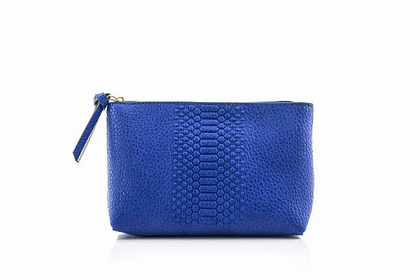 Blue leather cosmetic bag on white background.