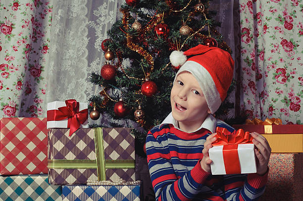 istock Happy child with christmas gift box. Christmastime 613345434