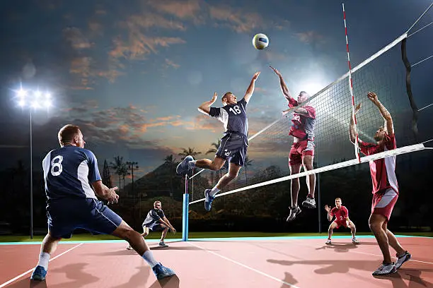 Professional volleyball players in action on the open air court