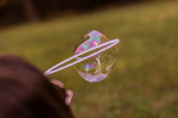 istock Young women blowing bubbles 613346378